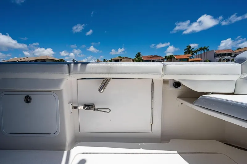  Yacht Photos Pics 2019 Mag Bay 33 CC boat interior with white seating and storage compartments.