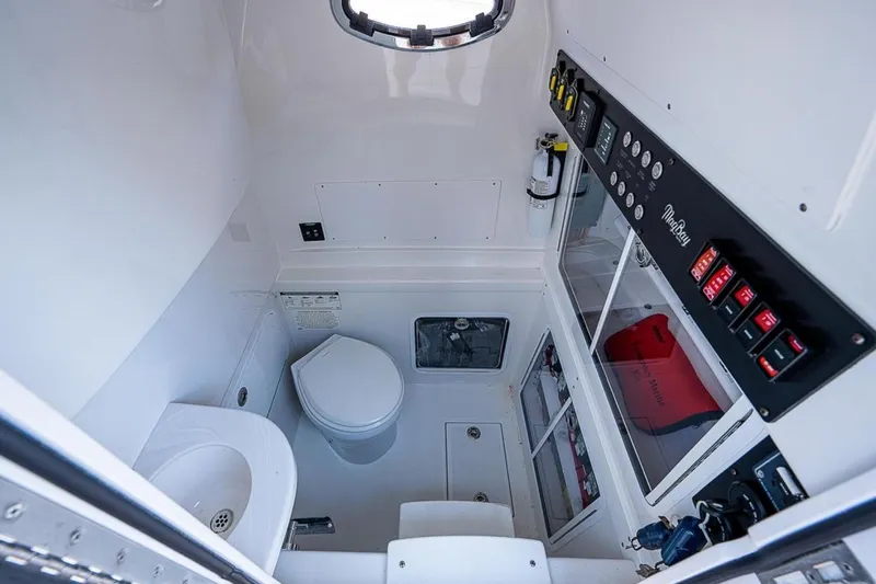  Yacht Photos Pics 2019 Mag Bay 33 CC boat interior with toilet, sink, and control panel.