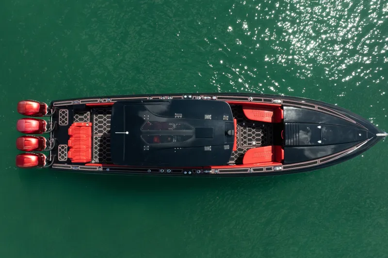  Yacht Photos Pics Aerial view of 2002 Midnight Express 39S Cuddy boat with red seating on green water.
