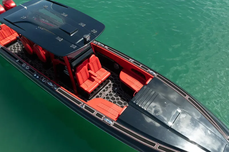  Yacht Photos Pics 2002 Midnight Express 39S Cuddy boat with red seating on turquoise water.