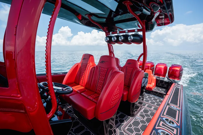  Yacht Photos Pics Luxurious red interior of 2002 Midnight Express 39S Cuddy boat on open water.