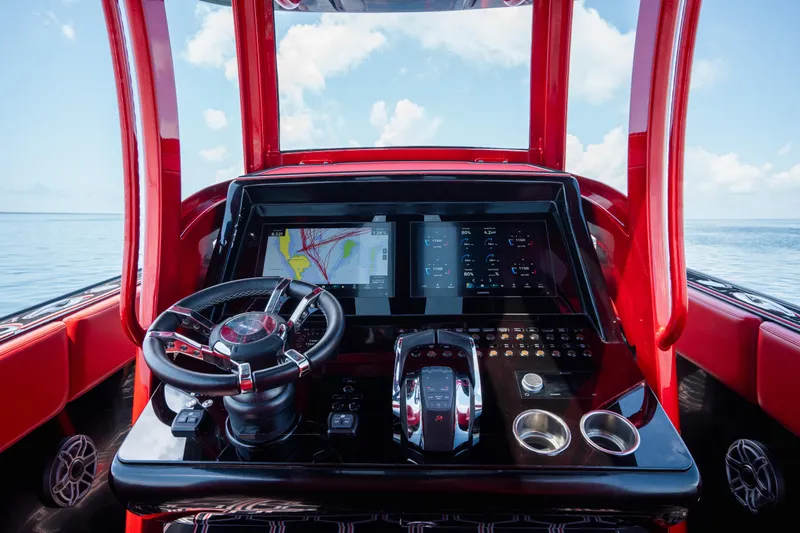  Yacht Photos Pics Cockpit of 2002 Midnight Express 39S Cuddy with modern navigation system and red interior.