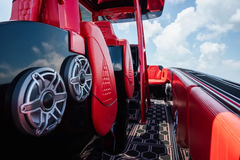  Yacht Photos Pics Red and black interior of 2002 Midnight Express 39S Cuddy boat with speakers and seating.