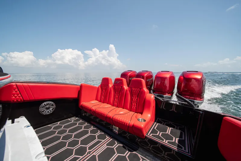  Yacht Photos Pics 2002 Midnight Express 39S Cuddy boat with red seating and multiple engines on open water.