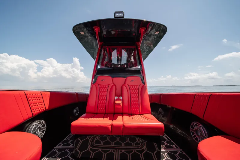  Yacht Photos Pics Luxurious red interior of 2002 Midnight Express 39S Cuddy boat under clear sky.