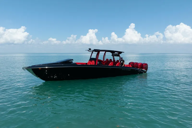  Yacht Photos Pics 2002 Midnight Express 39S Cuddy boat on calm ocean waters under a clear blue sky.