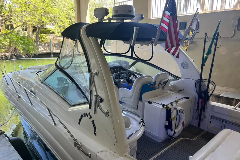 Wasn't Me Yacht Photos Pics 2006 Sea Ray 340 Sundancer boat docked, featuring cockpit and American flag.