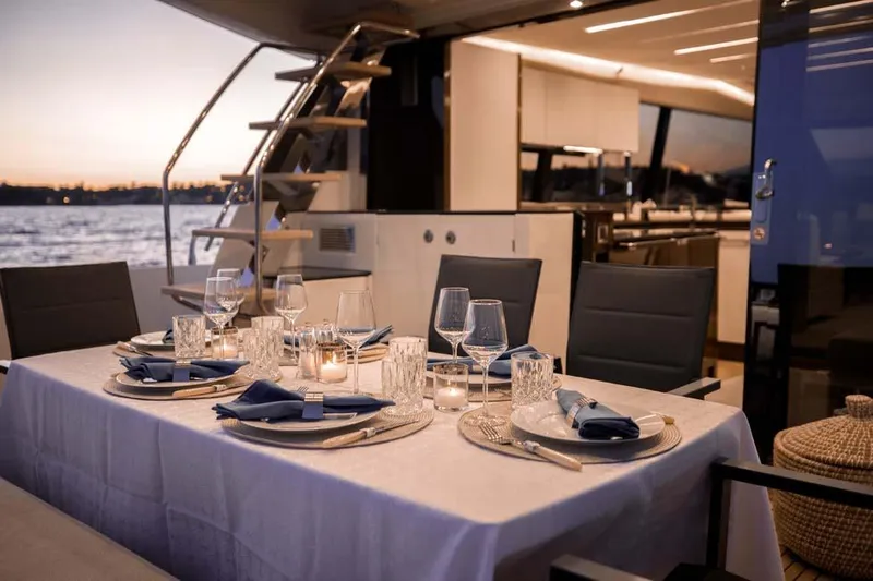  Yacht Photos Pics Luxurious dining setup on 2019 Prestige 680 S yacht at sunset.