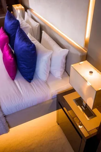  Yacht Photos Pics Luxurious bedroom interior on 2019 Prestige 680 S yacht with vibrant pillows and modern lighting.