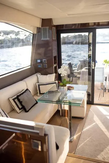  Yacht Photos Pics Luxurious interior of 2019 Prestige 680 S yacht with elegant seating and glass table.