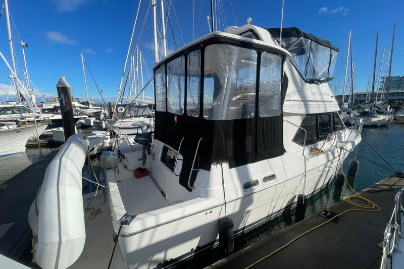 Happy Phantom Yacht Photos Pics 1996 Bayliner 4087 Aft Cabin Motoryacht docked at marina under clear blue sky.