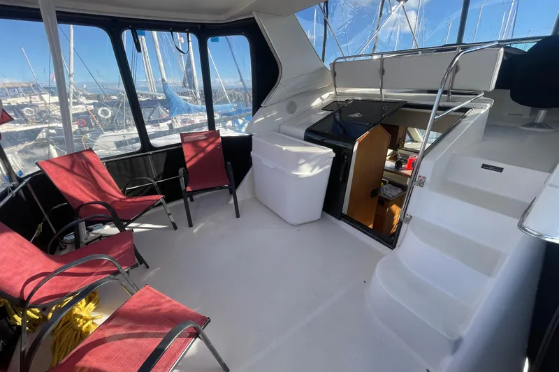 Happy Phantom Yacht Photos Pics 1996 Bayliner 4087 Aft Cabin Motoryacht interior with red chairs and marina view.