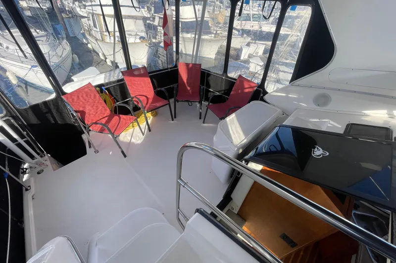 Happy Phantom Yacht Photos Pics 1996 Bayliner 4087 Aft Cabin Motoryacht interior with red chairs and marina view.