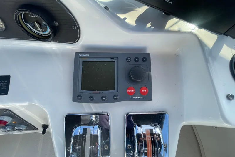 Happy Phantom Yacht Photos Pics 1996 Bayliner 4087 Aft Cabin Motoryacht helm with Raymarine autopilot controls.