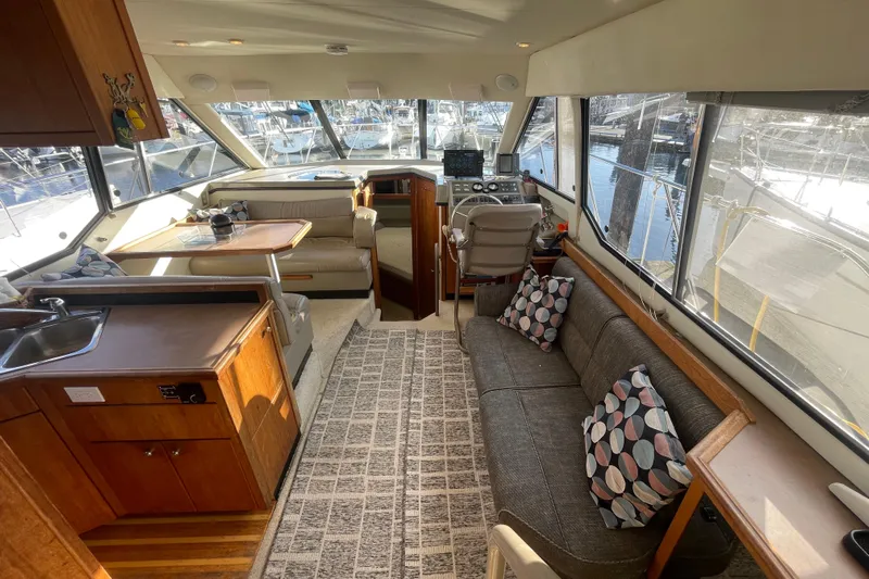 Happy Phantom Yacht Photos Pics 1996 Bayliner 4087 Aft Cabin Motoryacht interior with seating, kitchen, and helm.