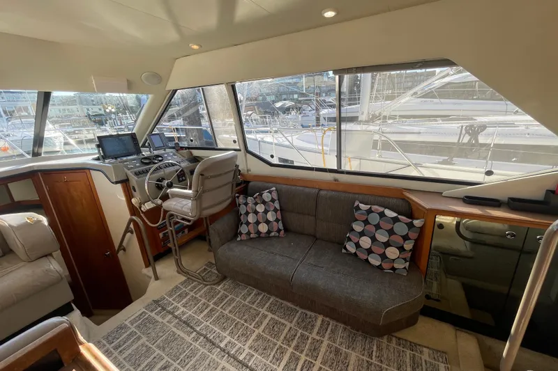 Happy Phantom Yacht Photos Pics Interior of 1996 Bayliner 4087 Aft Cabin Motoryacht with helm, seating, and large windows.