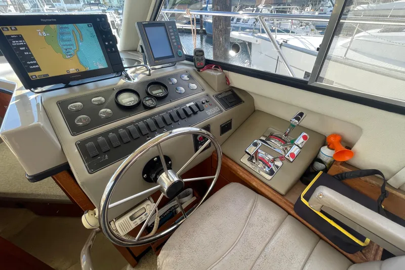 Happy Phantom Yacht Photos Pics 1996 Bayliner 4087 Aft Cabin Motoryacht helm with navigation equipment and controls.
