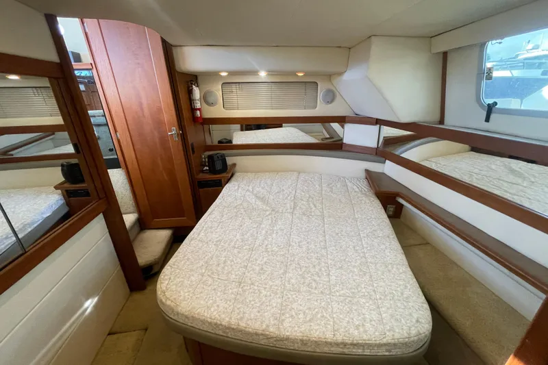 Happy Phantom Yacht Photos Pics 1996 Bayliner 4087 Aft Cabin Motoryacht bedroom with cozy bed and wooden accents.