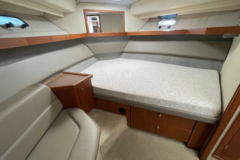 Happy Phantom Yacht Photos Pics 1996 Bayliner 4087 Aft Cabin Motoryacht interior with bed, seating, and wooden cabinetry.