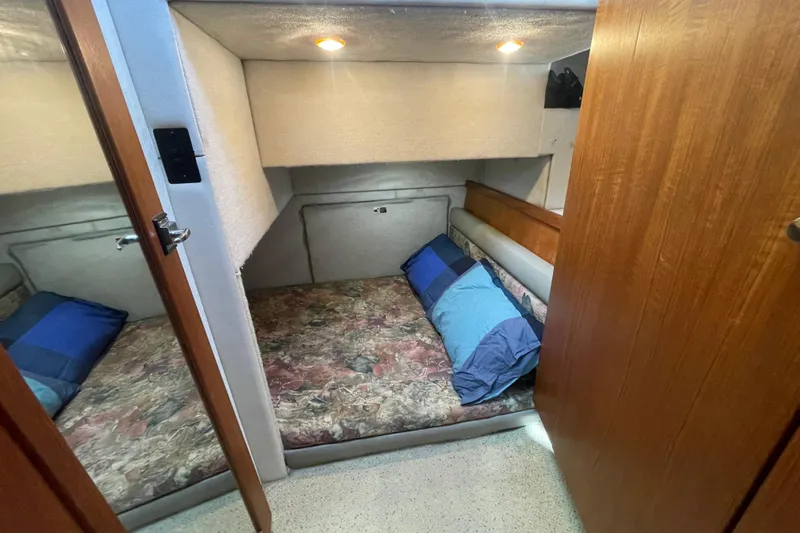 Happy Phantom Yacht Photos Pics Cozy cabin interior of 1996 Bayliner 4087 Aft Cabin Motoryacht with twin beds and wood paneling.