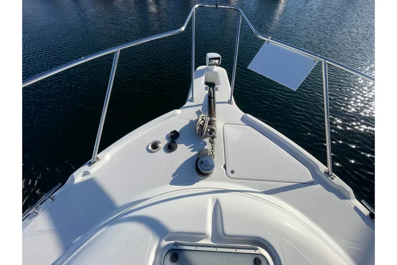 Happy Phantom Yacht Photos Pics 1996 Bayliner 4087 Aft Cabin Motoryacht bow with anchor, on calm water.