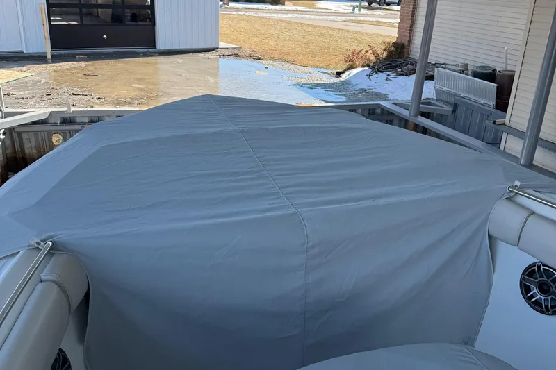  Yacht Photos Pics Covered 2016 Boston Whaler 330 Outrage boat docked, showcasing protective tarp and speakers.