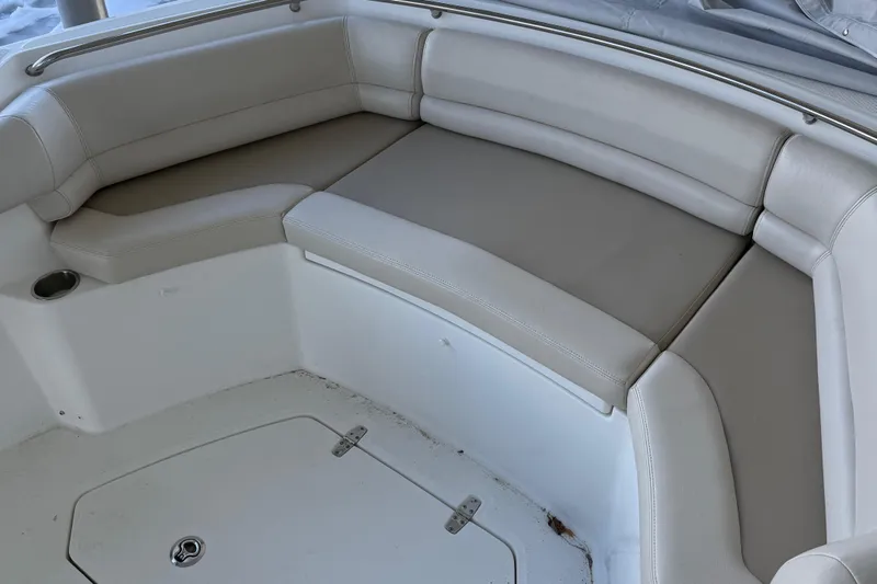  Yacht Photos Pics 2016 Boston Whaler 330 Outrage boat seating area with beige cushions.