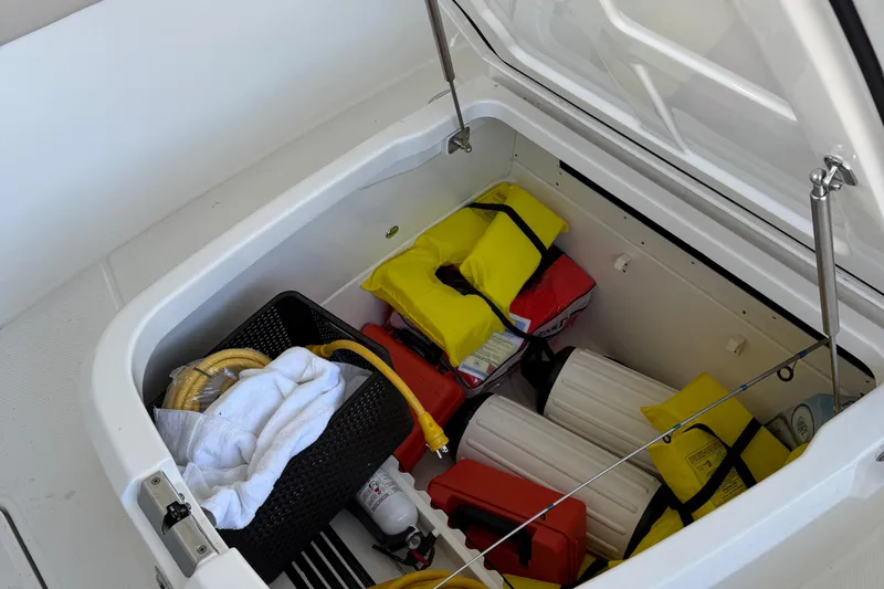  Yacht Photos Pics Storage compartment on 2016 Boston Whaler 330 Outrage with life jackets and boating gear.