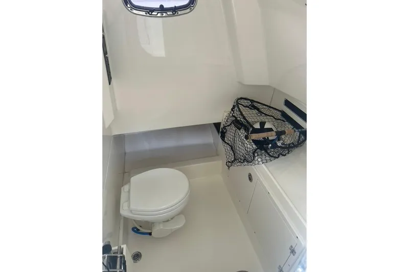  Yacht Photos Pics 2016 Boston Whaler 330 Outrage interior with toilet and fishing net.