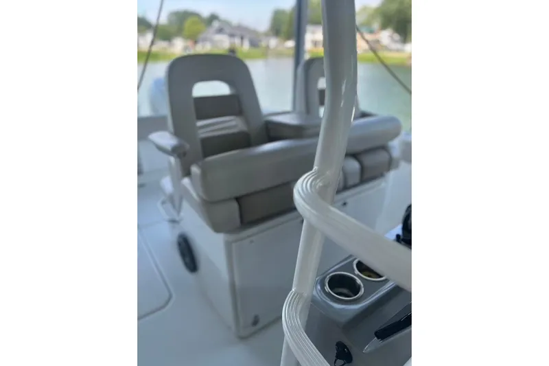  Yacht Photos Pics 2016 Boston Whaler 330 Outrage interior with cushioned seating and cup holders.