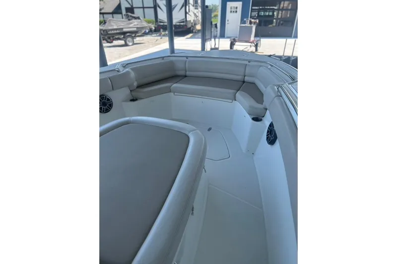  Yacht Photos Pics 2016 Boston Whaler 330 Outrage boat interior with cushioned seating and speakers.