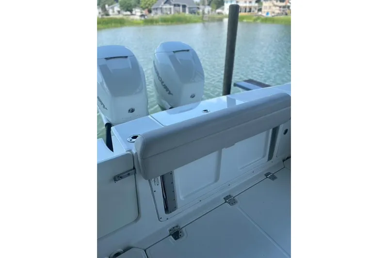  Yacht Photos Pics 2016 Boston Whaler 330 Outrage boat with dual Mercury engines, docked by a serene waterfront.