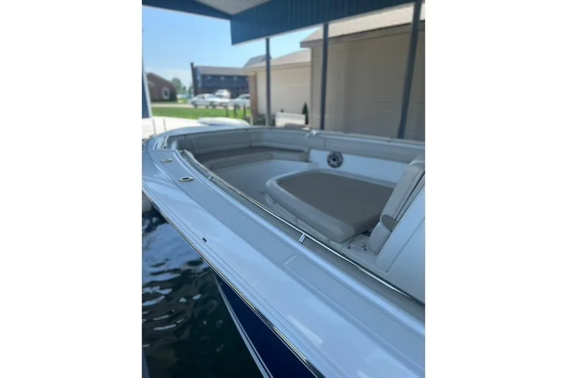  Yacht Photos Pics 2016 Boston Whaler 330 Outrage boat docked, showcasing sleek design and comfortable seating.