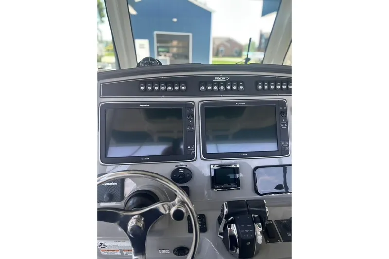  Yacht Photos Pics 2016 Boston Whaler 330 Outrage helm with dual Raymarine displays and controls.