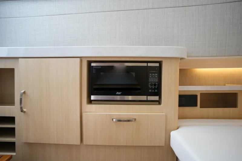  Yacht Photos Pics 2024 Regal 38 SAV interior with built-in microwave and modern cabinetry.