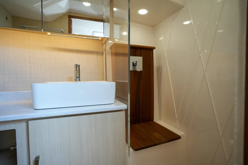 Yacht Photos Pics 2024 Regal 38 SAV bathroom with modern sink and wooden accents.