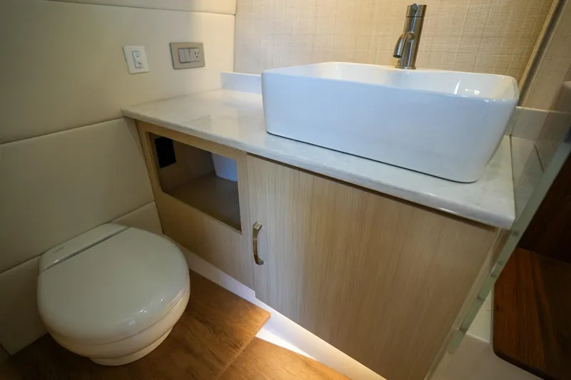  Yacht Photos Pics Modern bathroom in 2024 Regal 38 SAV yacht with sink and toilet.