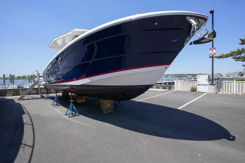  Yacht Photos Pics 2024 Regal 38 SAV boat on stands in a marina parking lot.