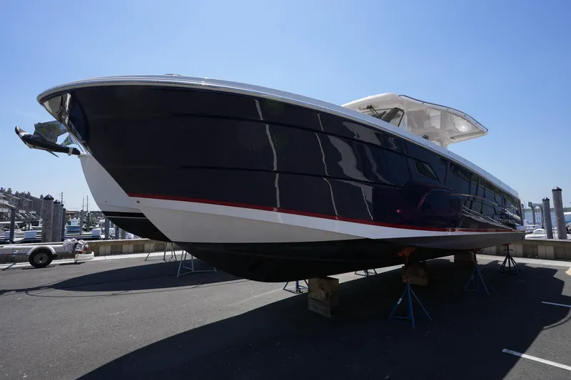  Yacht Photos Pics 2024 Regal 38 SAV boat on display at a marina under clear blue sky.