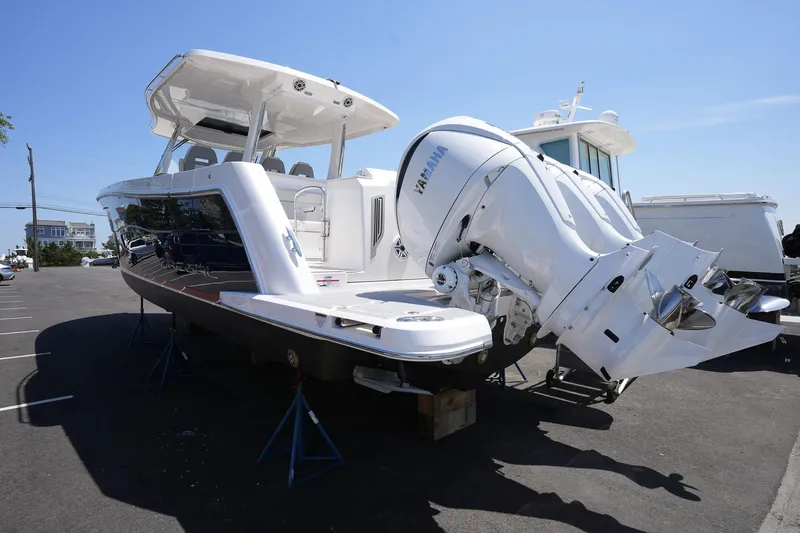  Yacht Photos Pics 2024 Regal 38 SAV boat with powerful outboard engines, displayed on a sunny day.