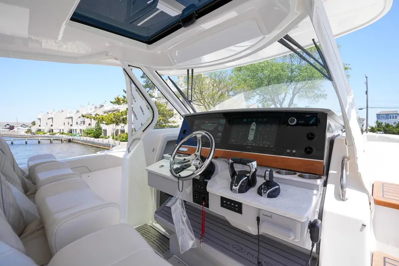  Yacht Photos Pics 2024 Regal 38 SAV boat cockpit with modern controls and luxurious seating.