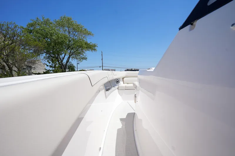  Yacht Photos Pics 2024 Regal 38 SAV boat deck with sleek white design under clear blue sky.