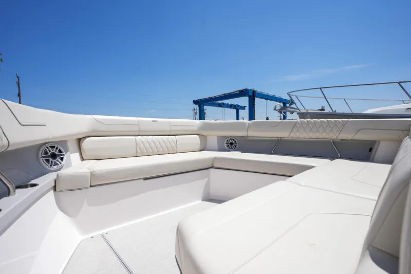  Yacht Photos Pics 2024 Regal 38 SAV boat interior with luxurious seating under clear blue sky.
