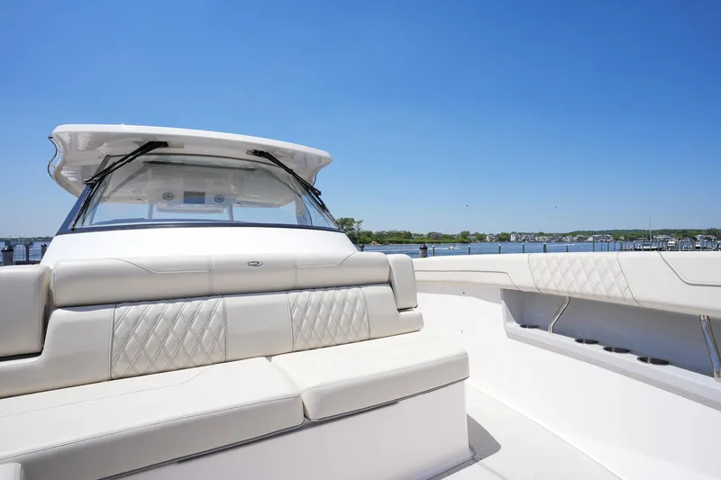  Yacht Photos Pics 2024 Regal 38 SAV luxury boat with spacious seating and sleek design on a sunny day.