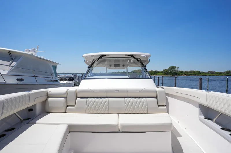  Yacht Photos Pics 2024 Regal 38 SAV luxury boat with spacious seating and sleek design on a sunny day.