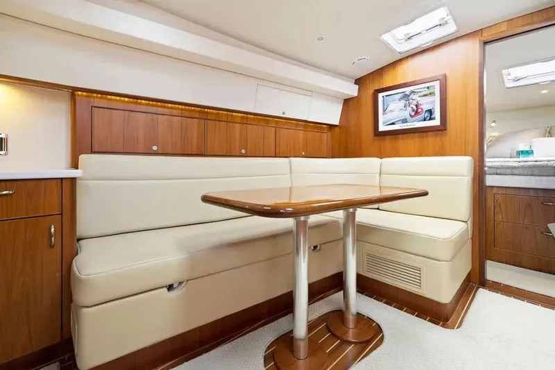  Yacht Photos Pics Luxurious interior of 2012 Cabo 44 Hardtop Express yacht with elegant seating and wooden finishes.