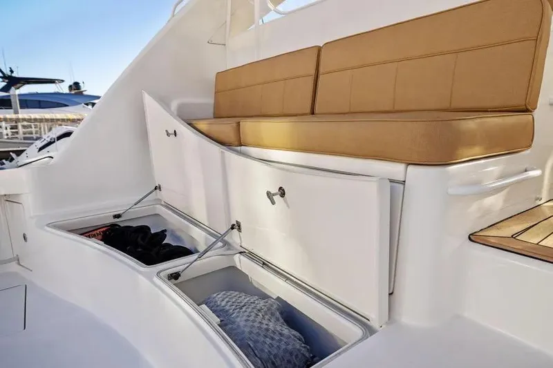  Yacht Photos Pics 2012 Cabo 44 Hardtop Express boat with cushioned seating and open storage compartments.