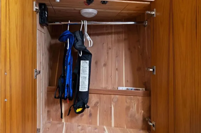  Yacht Photos Pics Wooden closet with life jackets inside a 2012 Cabo 44 Hardtop Express boat.