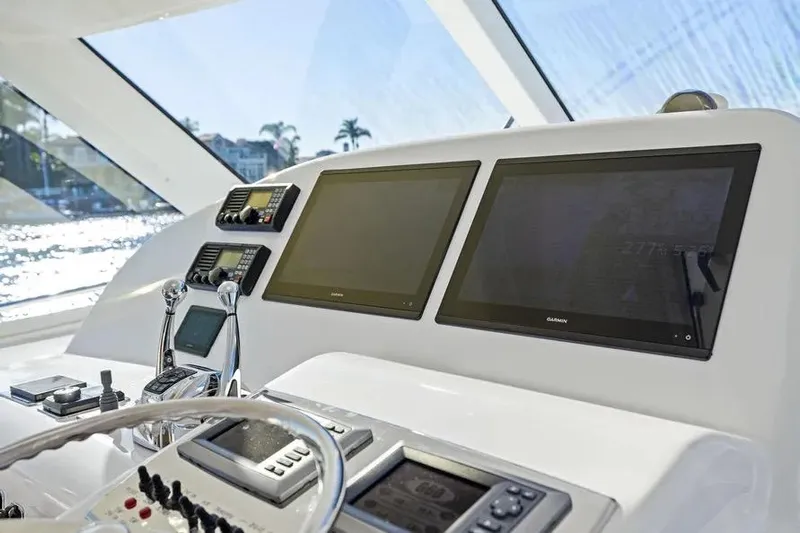  Yacht Photos Pics Helm of 2012 Cabo 44 Hardtop Express with dual Garmin displays and controls.