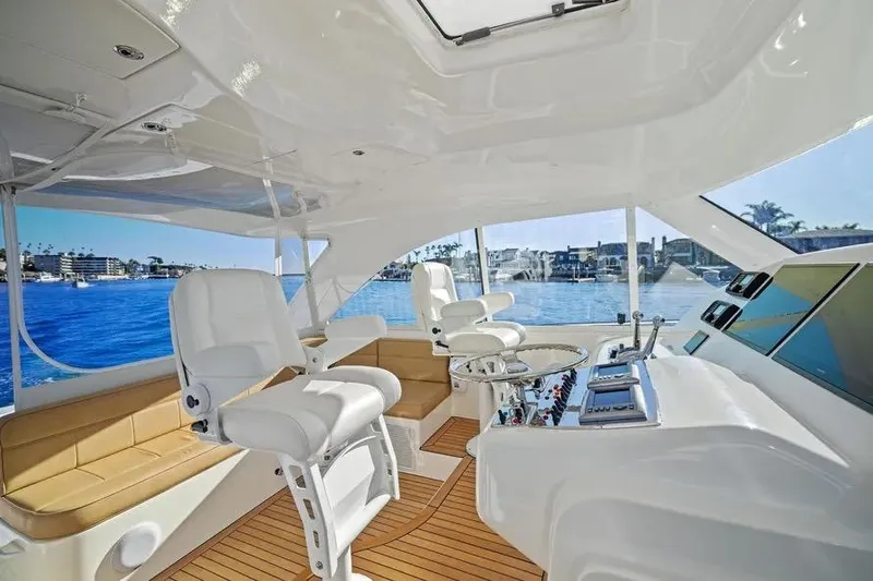  Yacht Photos Pics Luxurious interior of 2012 Cabo 44 Hardtop Express yacht with helm and seating.